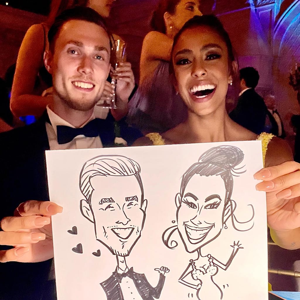 Bride and groom happily showing their caricatures